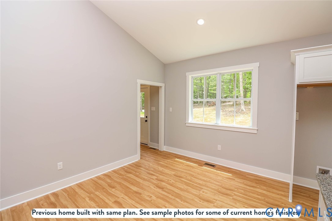 14502 Gatewood Road Dewitt, VA 23840 - Photo 17 of 22 a view of an empty room with wooden floor and a window