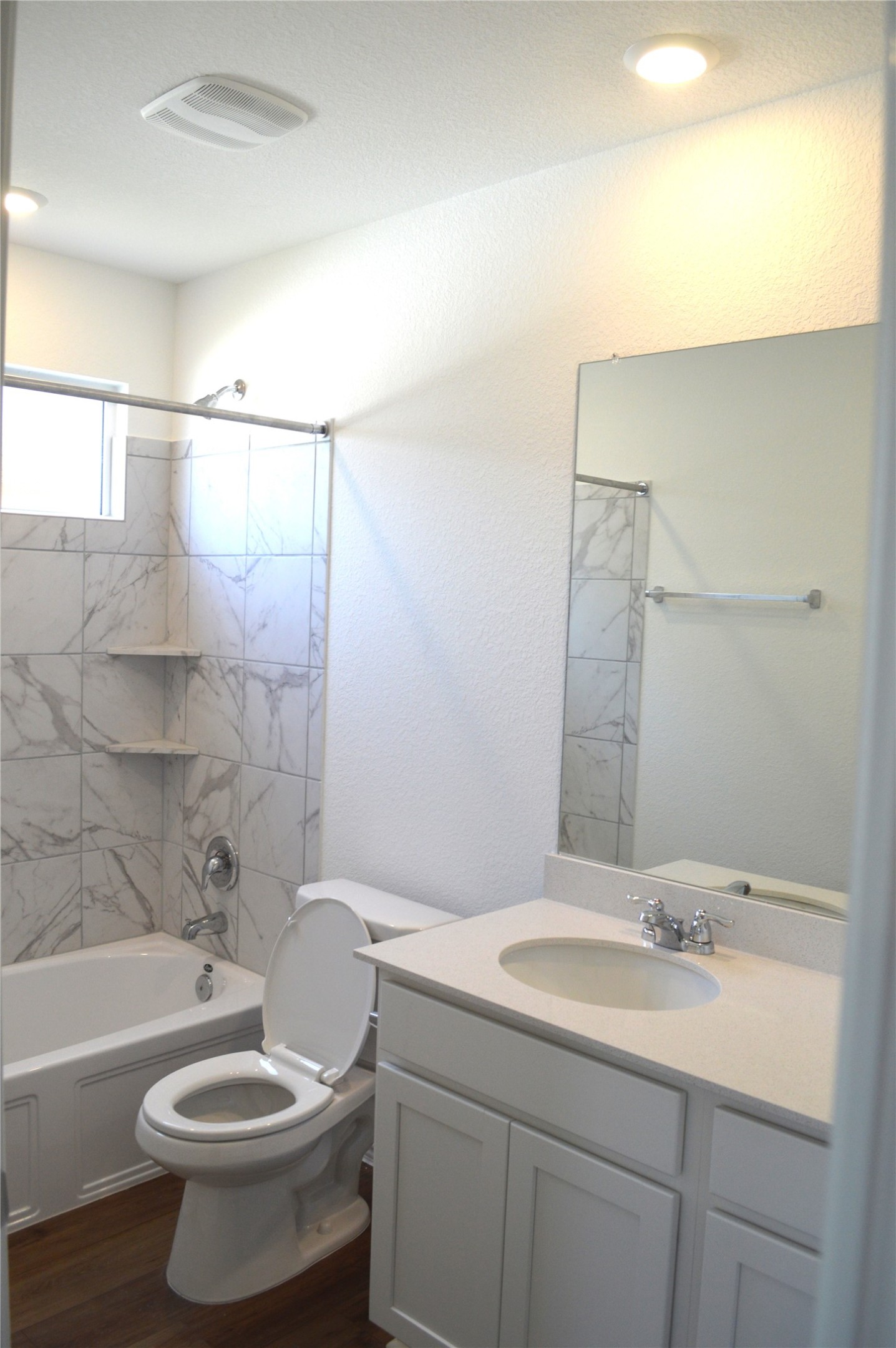 1524 Marley Kyle, TX 78640 - Photo 16 of 22 Bathroom with vanity, bathing tub / shower combination, and dark wood finished floors