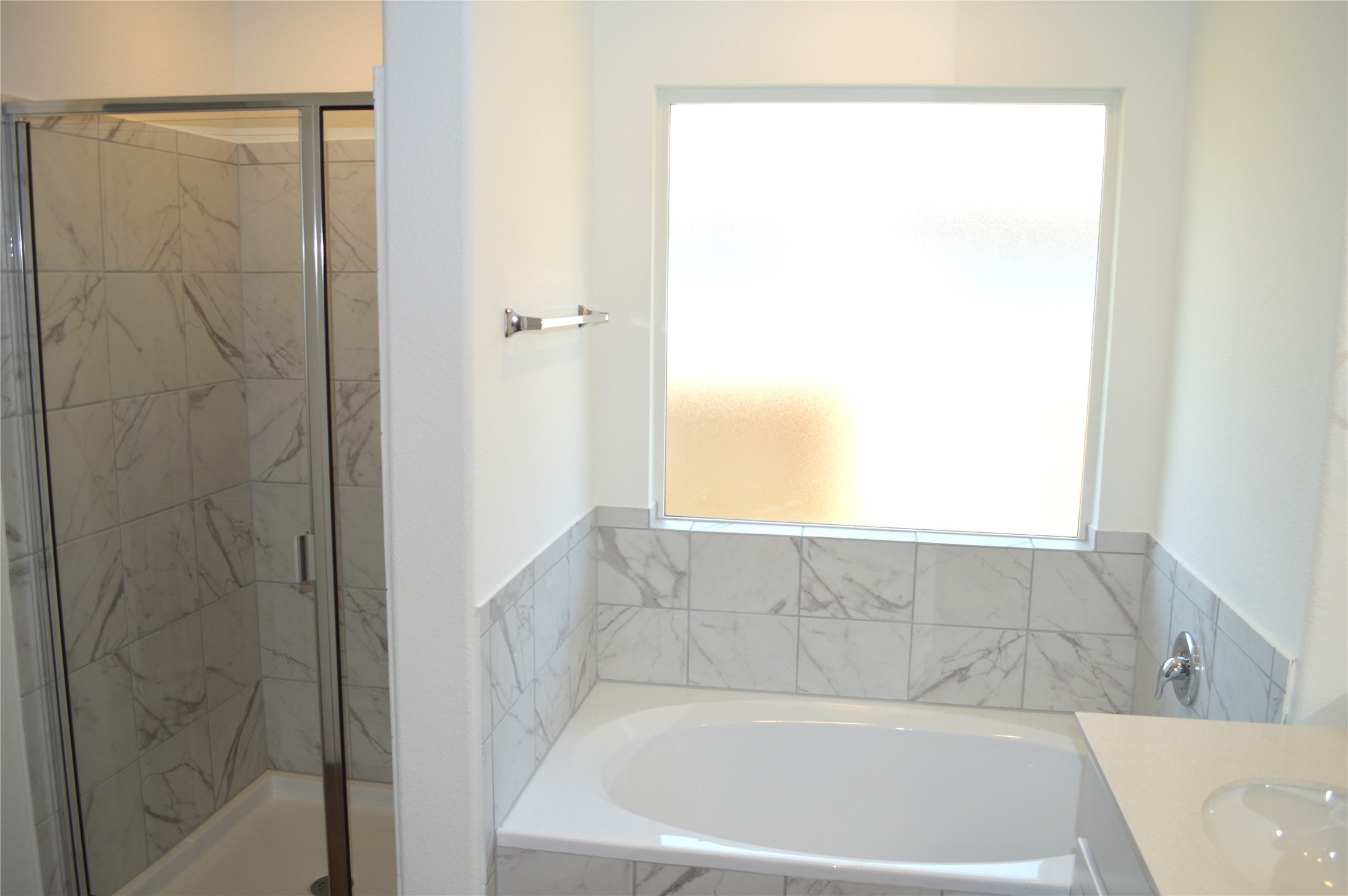 1524 Marley Kyle, TX 78640 - Photo 9 of 22 Bathroom with plenty of natural light, a marble finish shower, vanity, and a garden tub