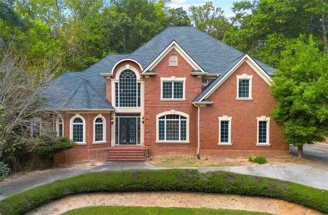 a front view of house with yard and green space