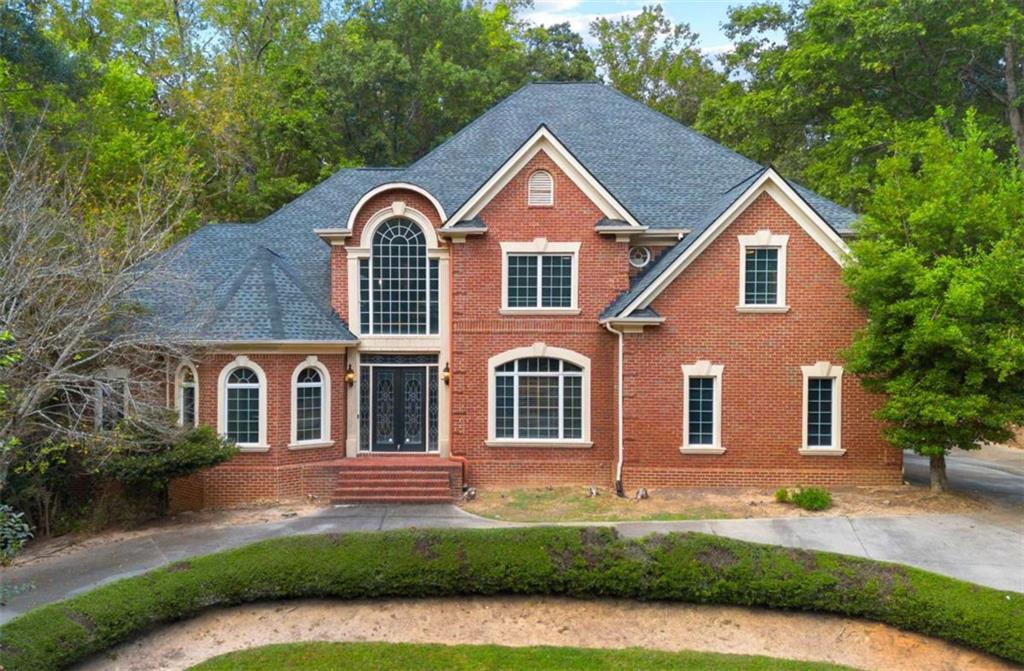 a front view of house with yard and green space