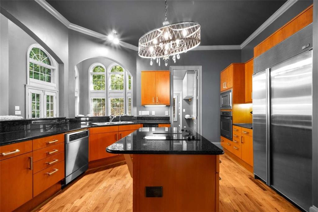 1670 Riverside Road Roswell, GA 30076 - Photo 18 of 88 a kitchen with stainless steel appliances granite countertop a refrigerator a sink dishwasher a stove and a dining table with wooden floor