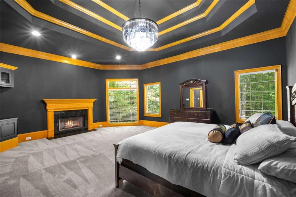 1670 Riverside Road Roswell, GA 30076 - Photo 33 of 88 a bedroom with a bed and a fireplace