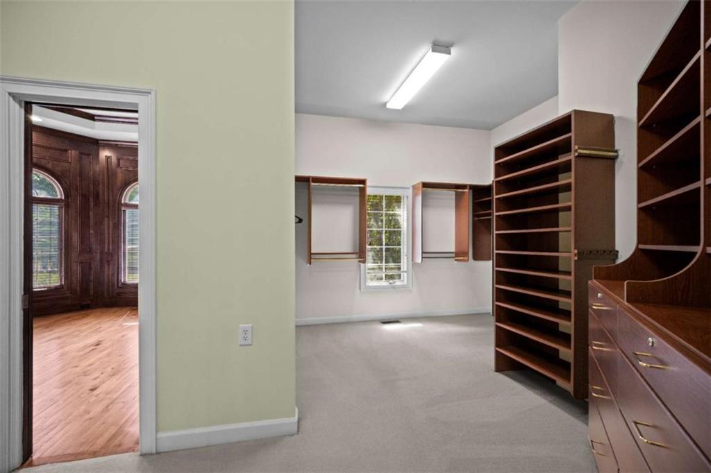 1670 Riverside Road Roswell, GA 30076 - Photo 43 of 88 a view of walk in closet with clothes and shoes