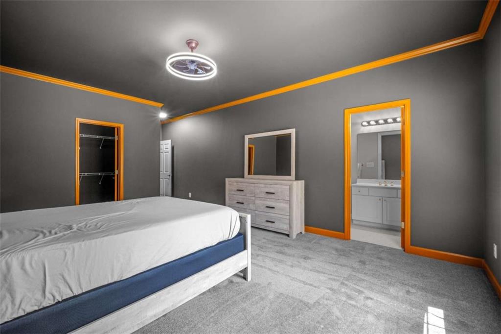 1670 Riverside Road Roswell, GA 30076 - Photo 50 of 88 a bedroom with a bed and a flat screen tv