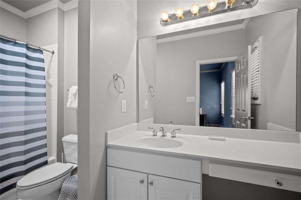 1670 Riverside Road Roswell, GA 30076 - Photo 55 of 88 a bathroom with a sink a toilet a shower and a mirror