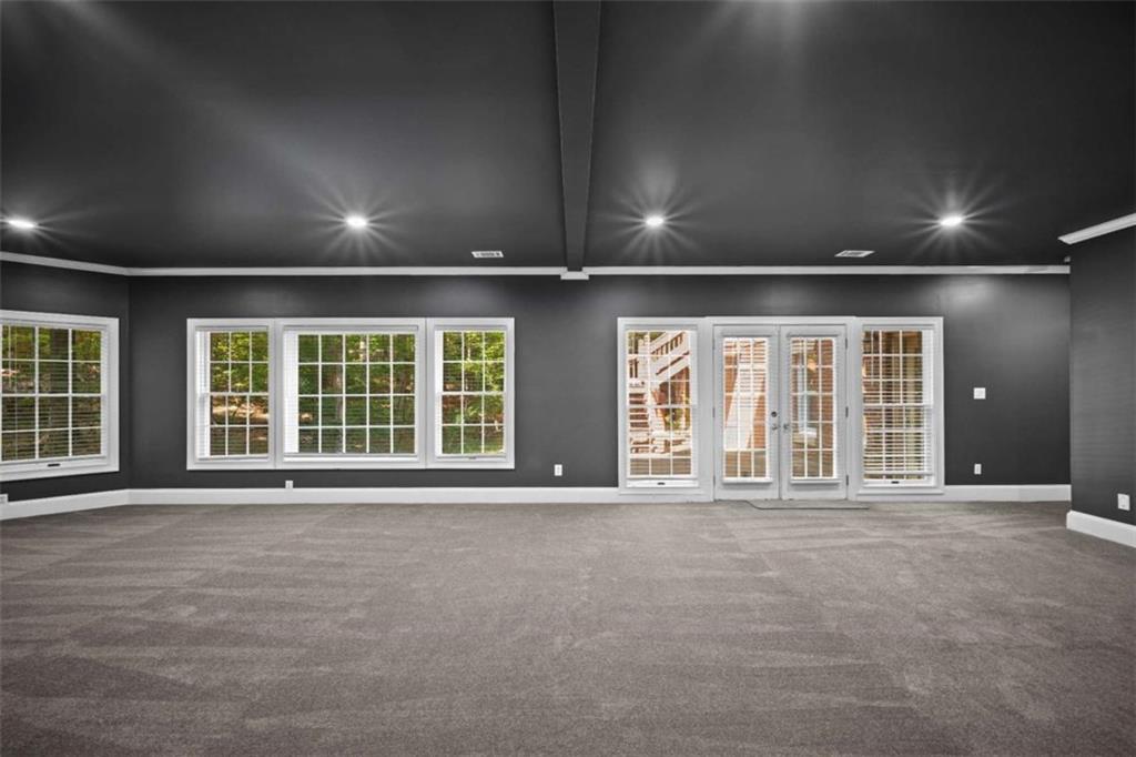 1670 Riverside Road Roswell, GA 30076 - Photo 61 of 88 a view of an empty room with a fireplace and large windows