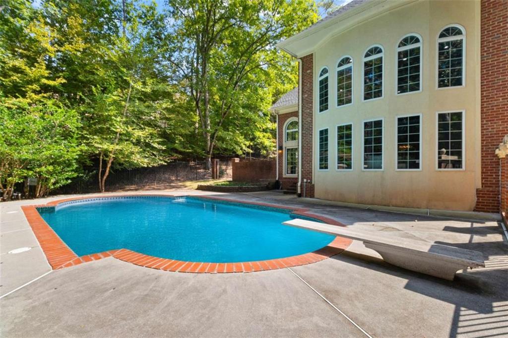 1670 Riverside Road Roswell, GA 30076 - Photo 76 of 88 a view of a swimming pool with a lounge chairs