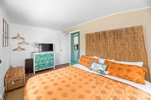 a bed sitting in a bedroom next to a window