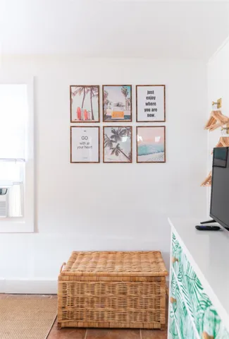 a bedroom with a bed and painting on the wall