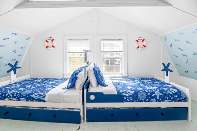 a bed sitting in a bedroom next to a window