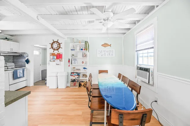 a living room with furniture and a kitchen view
