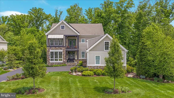 a aerial view of a house with a yard and potted plants