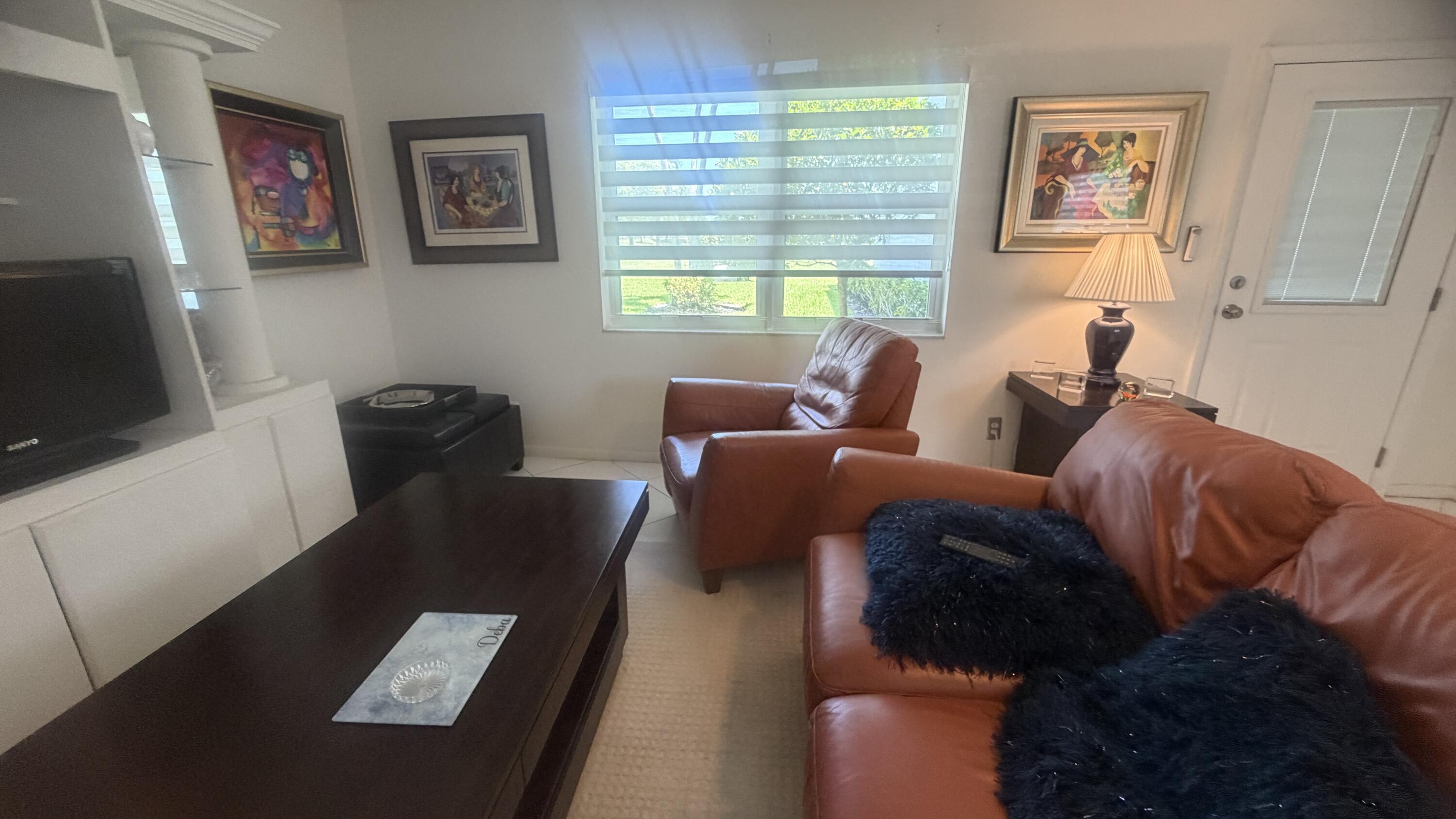 930 Normandy Trail Delray Beach, FL 33484 - Photo 14 of 34 a living room with furniture and a window