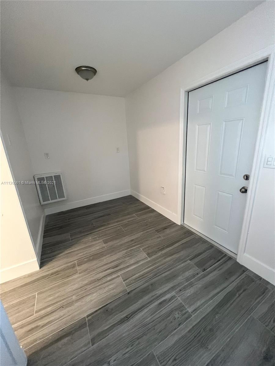 8935 Southwest 38th Street Miami, FL 33165 - Photo 16 of 24 a view of a room with wooden floor and staircase