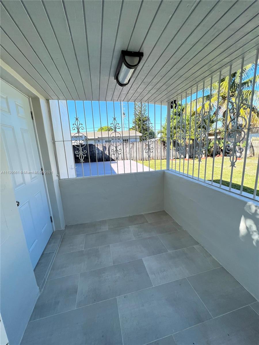 8935 Southwest 38th Street Miami, FL 33165 - Photo 17 of 24 a view of an empty room and a window