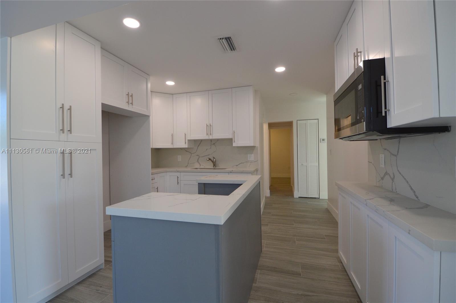 8935 Southwest 38th Street Miami, FL 33165 - Photo 4 of 24 a kitchen with a sink microwave and refrigerator