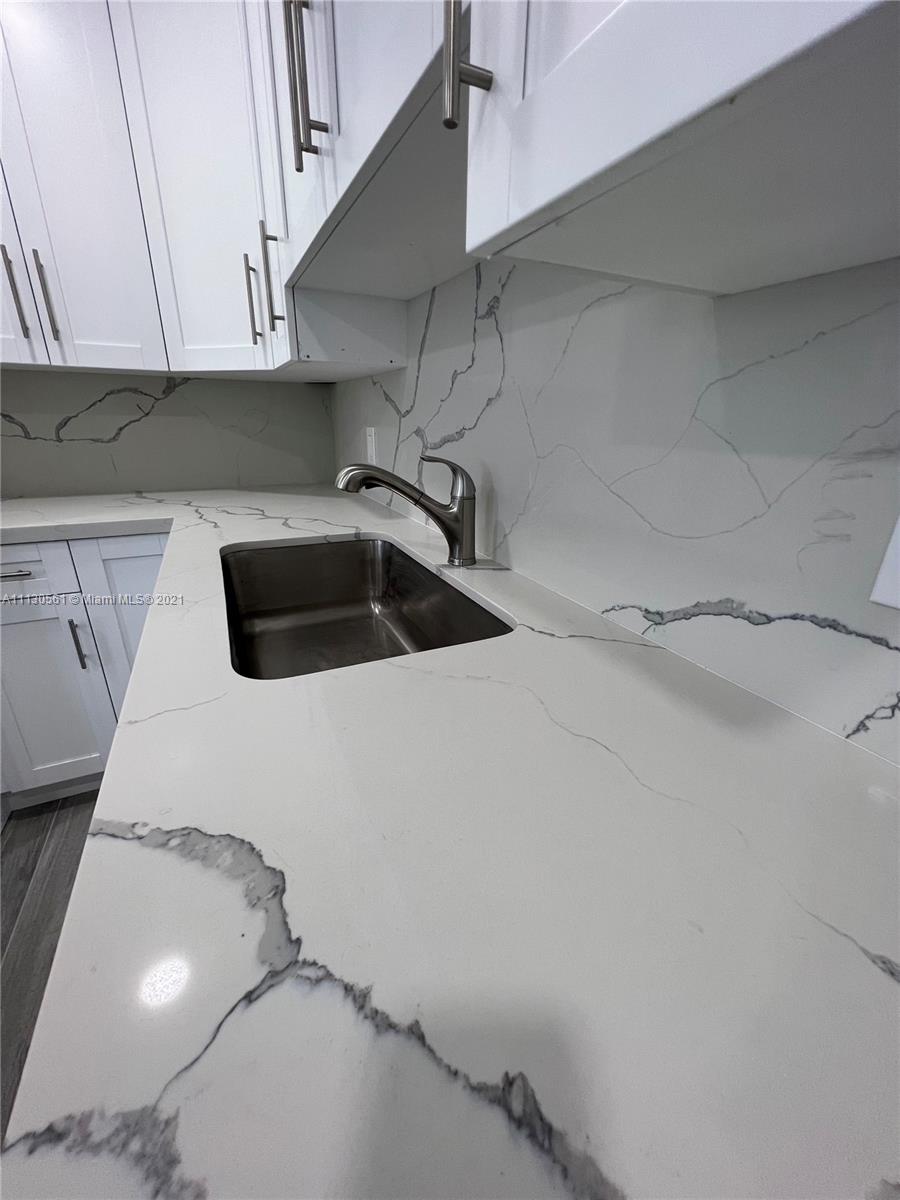 8935 Southwest 38th Street Miami, FL 33165 - Photo 6 of 24 a kitchen with a sink and cabinets