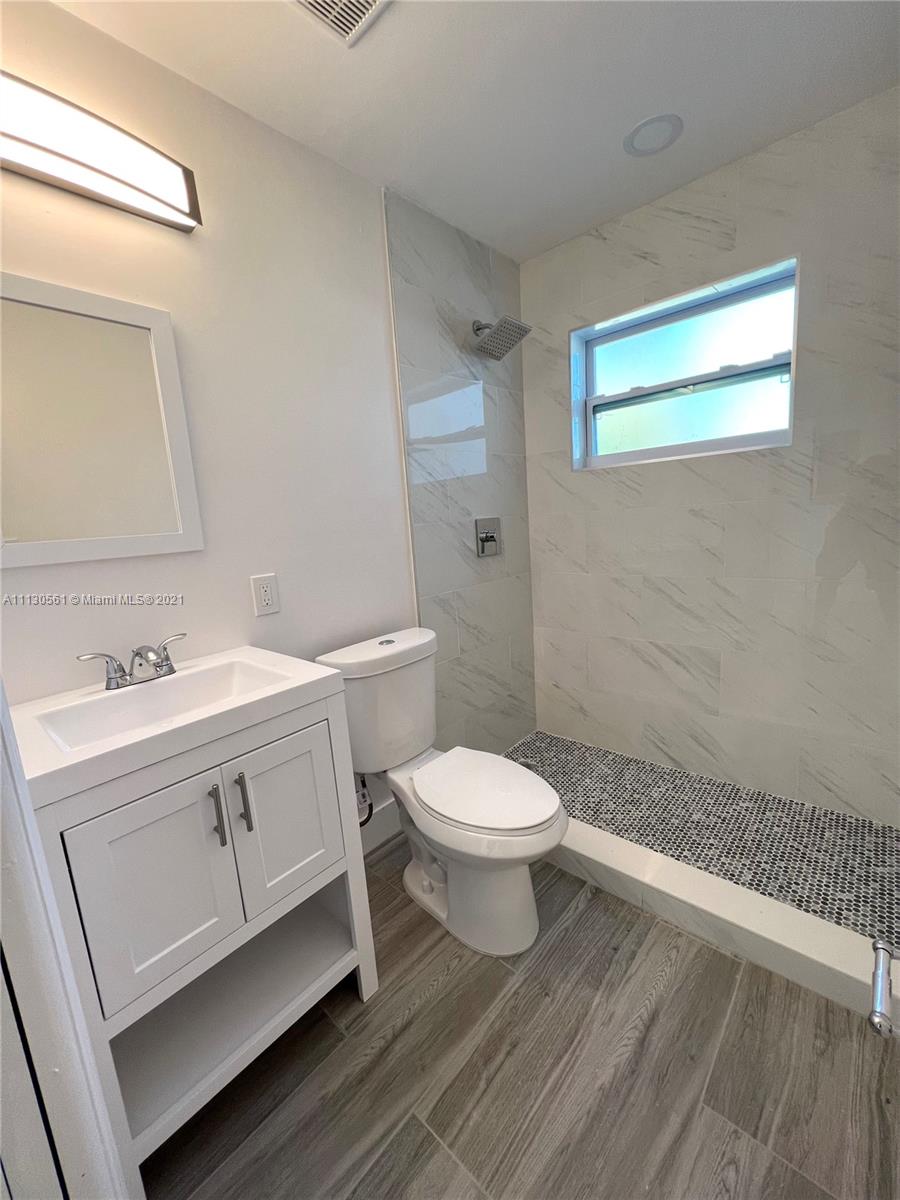 8935 Southwest 38th Street Miami, FL 33165 - Photo 10 of 24 a bathroom with a sink a toilet and shower