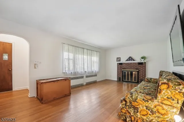 a view of a livingroom with wooden floor and furniture