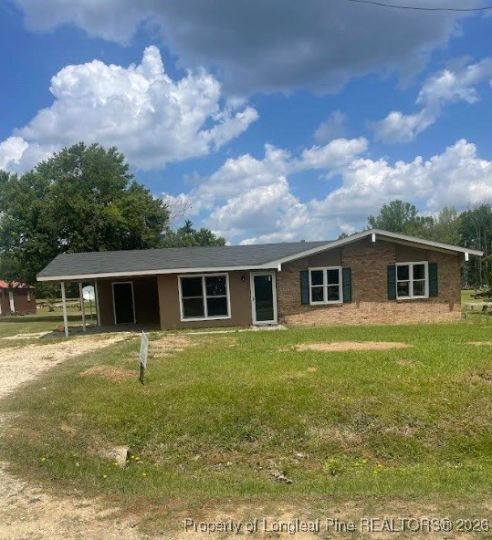a front view of house with yard and trees