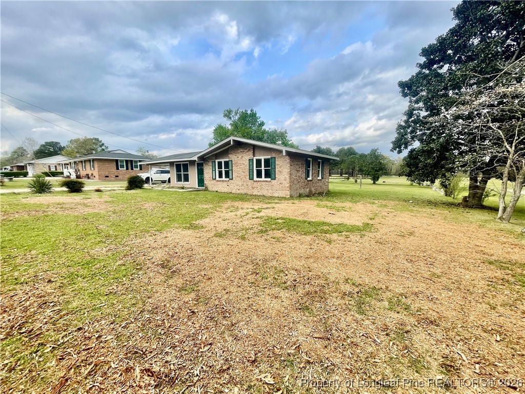 1374 McLean Chapel Church Road Bunnlevel, NC 28323 - Photo 14 of 17 a view of a house with a yard and sitting area