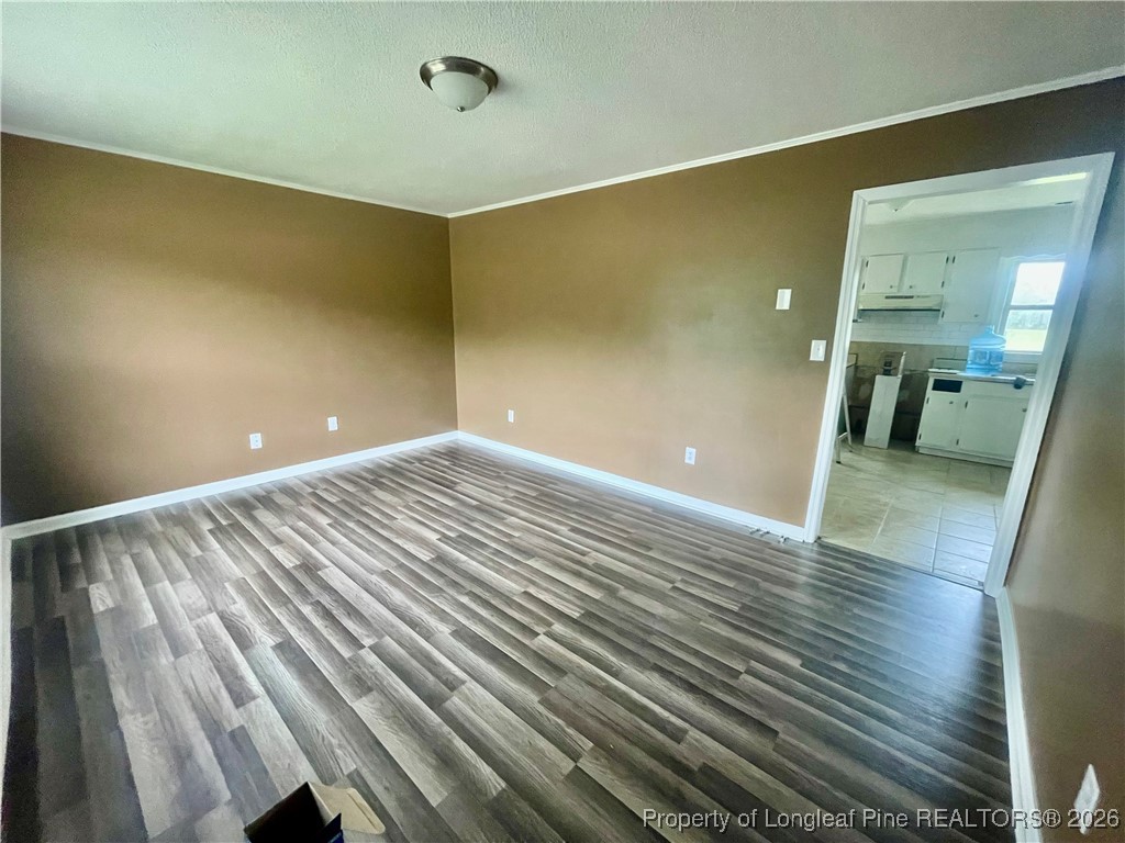 1374 McLean Chapel Church Road Bunnlevel, NC 28323 - Photo 4 of 17 a view of empty room with wooden floor