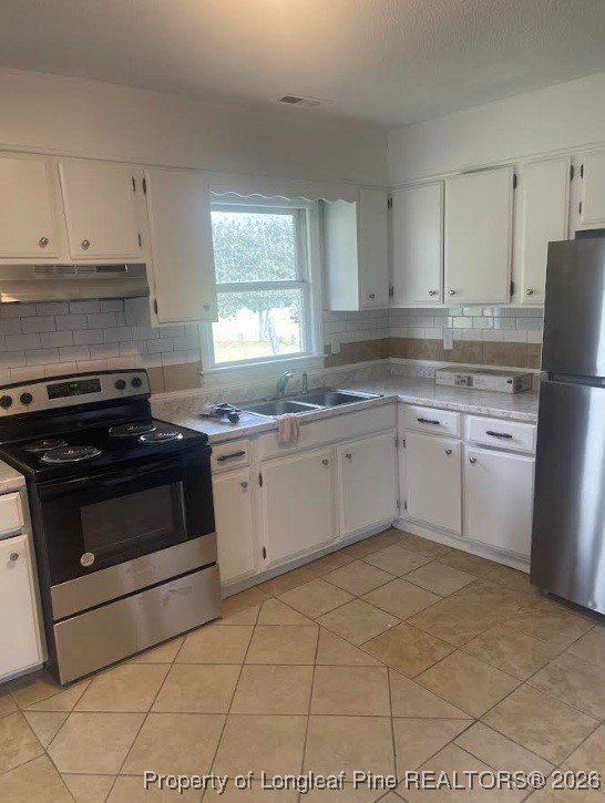 1374 McLean Chapel Church Road Bunnlevel, NC 28323 - Photo 7 of 17 a kitchen with a stove sink and cabinets