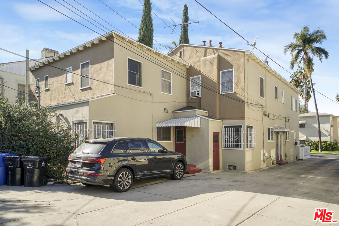 116 South Kings Road Los Angeles, CA 90048 - Photo 3 of 12 a car parked in front of a white house