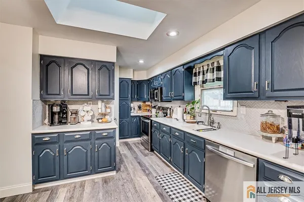 a kitchen with lots of counter top space cabinets and appliances