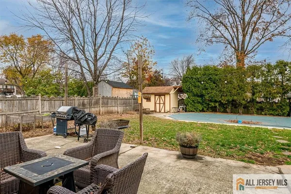 a view of a patio with couches table and chairs and potted plants