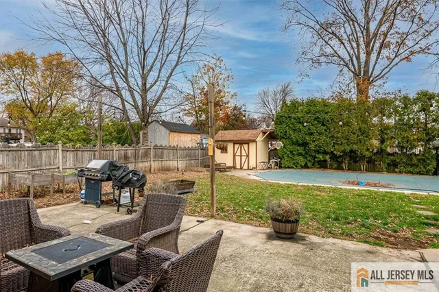 a view of a patio with couches table and chairs and potted plants