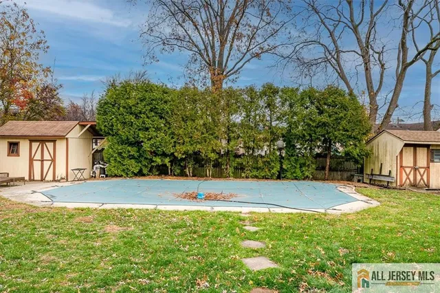 a view of yard with swimming pool and green space