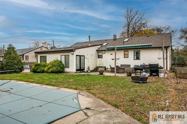 a view of a house with backyard sitting area and garden