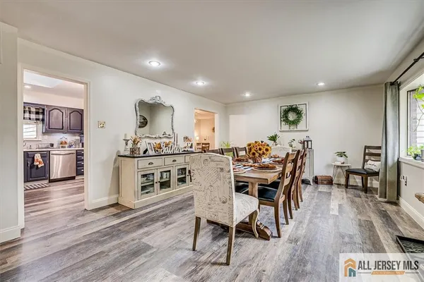 a view of a dining room with furniture kitchen and wooden floor