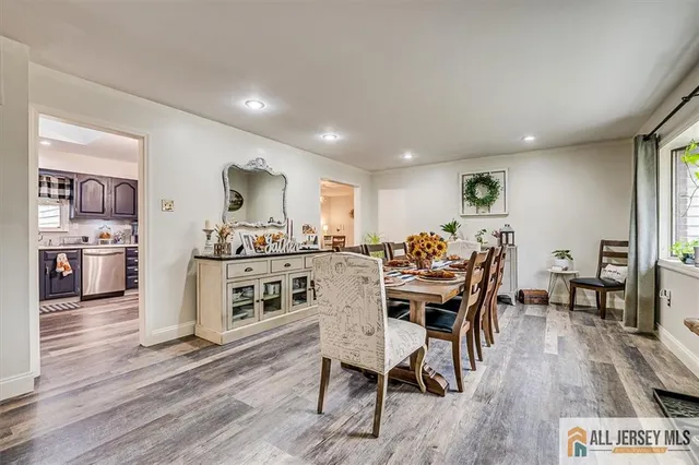 a view of a dining room with furniture kitchen and wooden floor