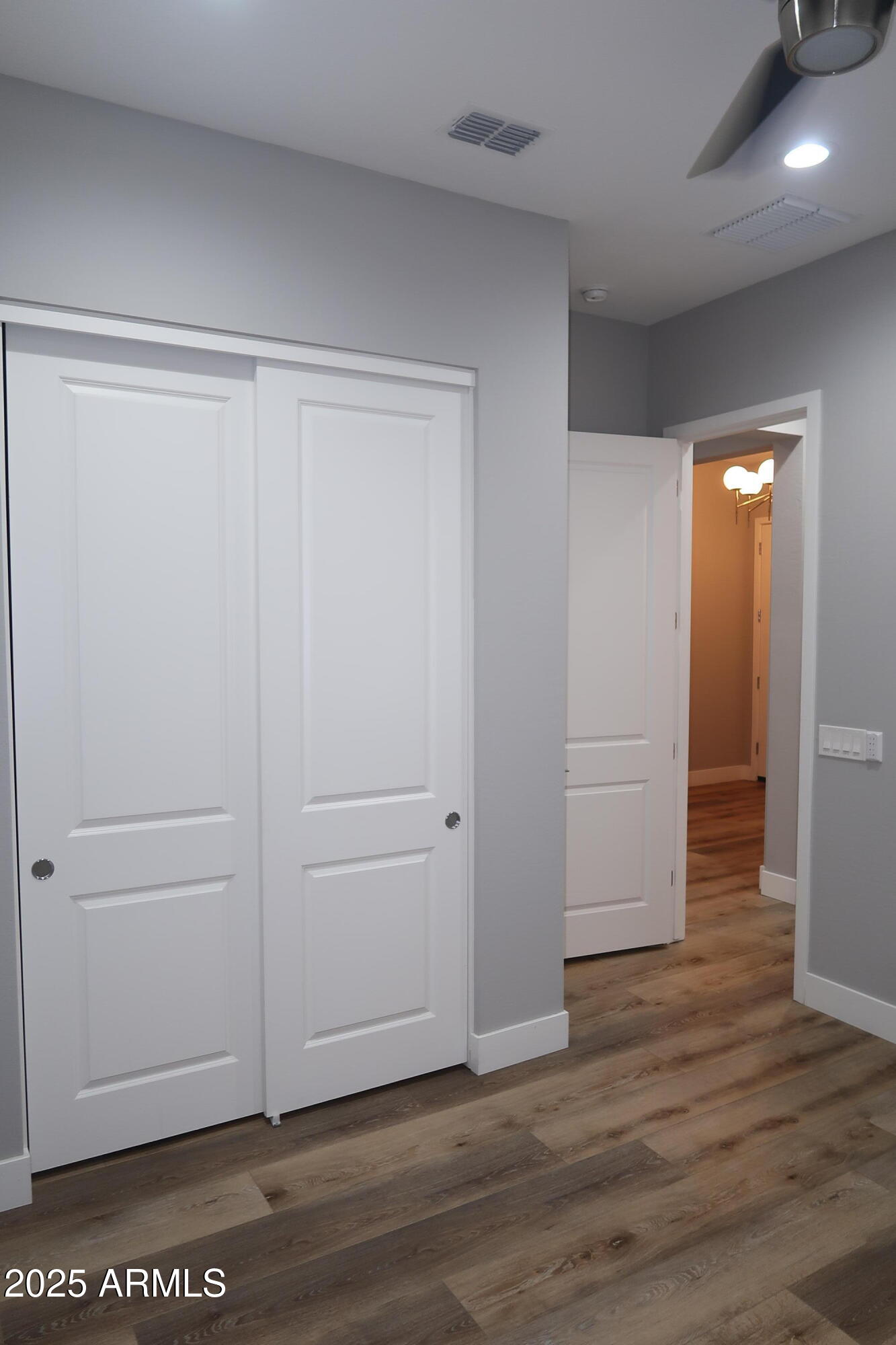 2852 East Robin Lane Phoenix, AZ 85050 - Photo 23 of 58 an empty room with wooden floor & closet area