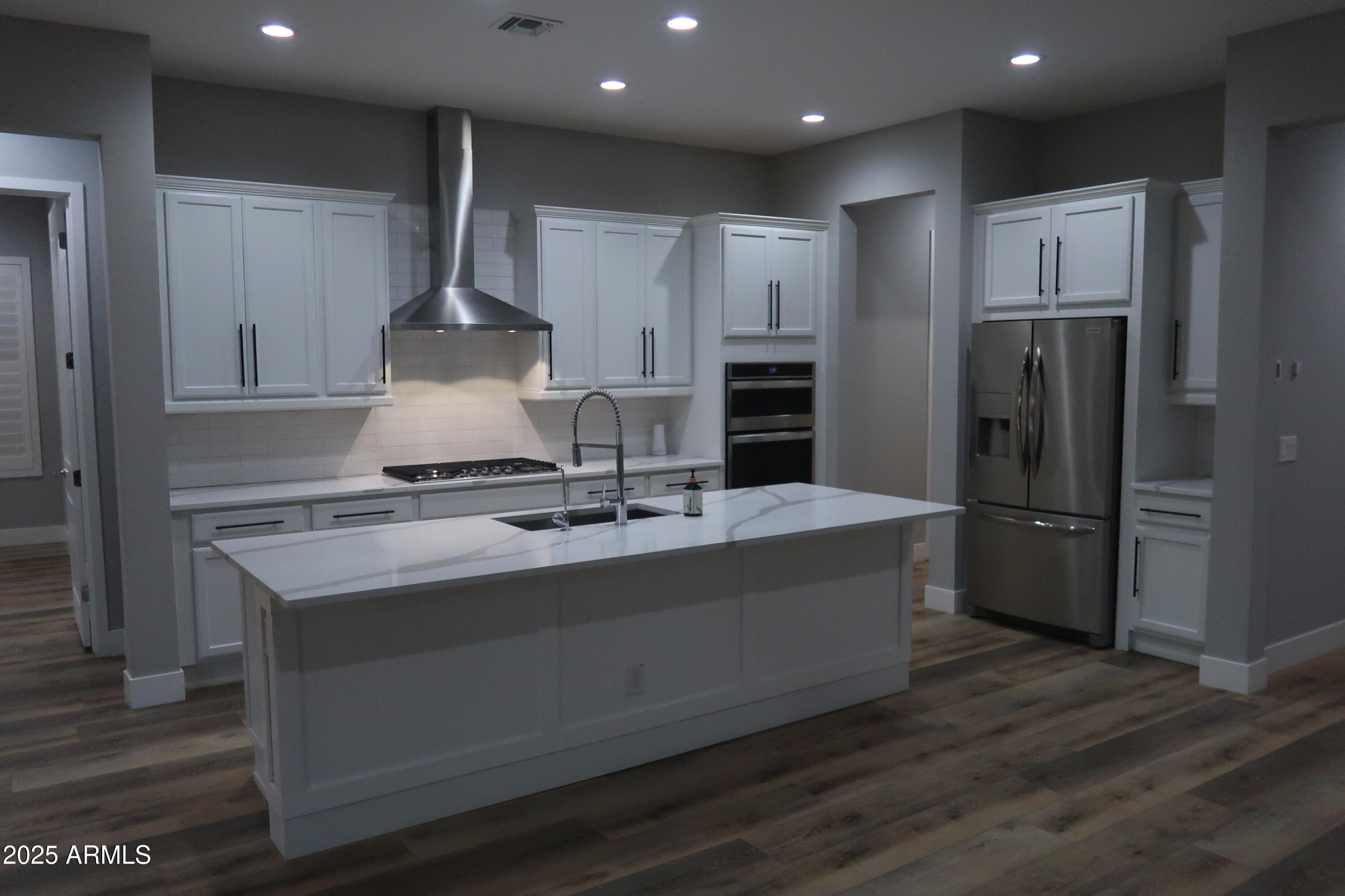 2852 East Robin Lane Phoenix, AZ 85050 - Photo 4 of 58 a kitchen with kitchen island stainless steel appliances a sink and refrigerator