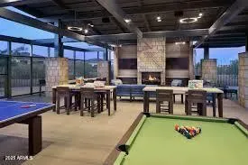 a living room with furniture a flat screen tv and kitchen view