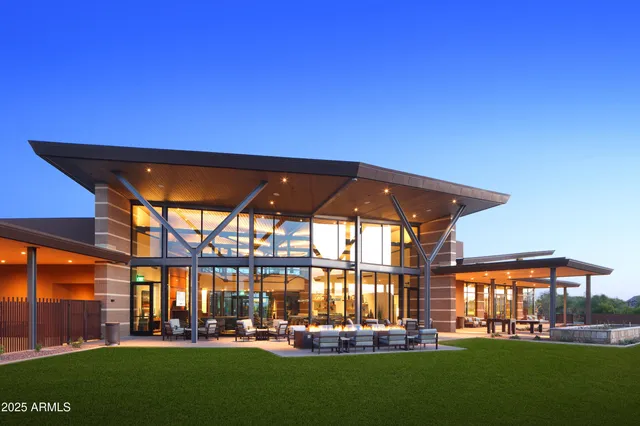 a room with lots of tables a large window and chairs