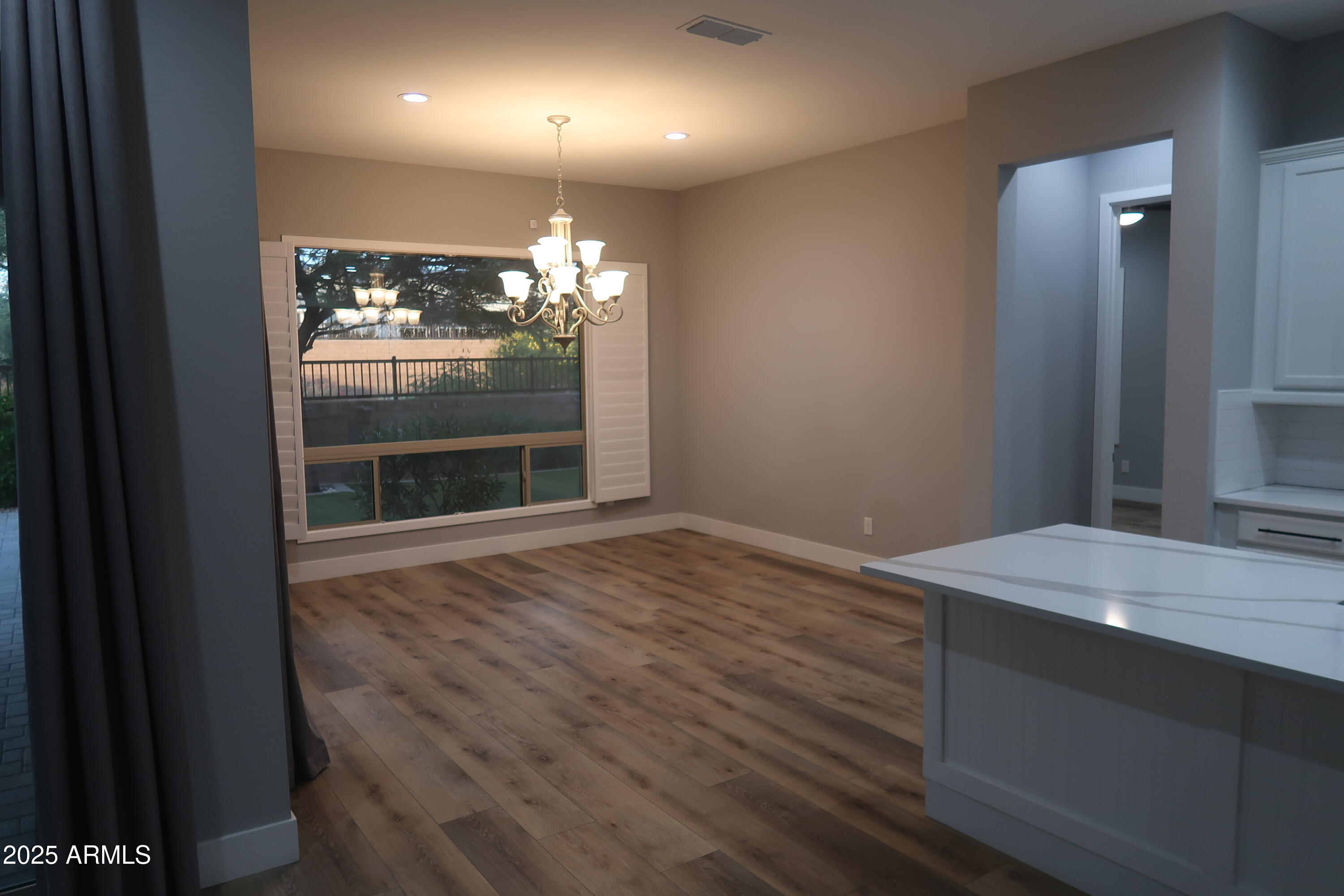 2852 East Robin Lane Phoenix, AZ 85050 - Photo 7 of 58 a room with window and a wooden floor