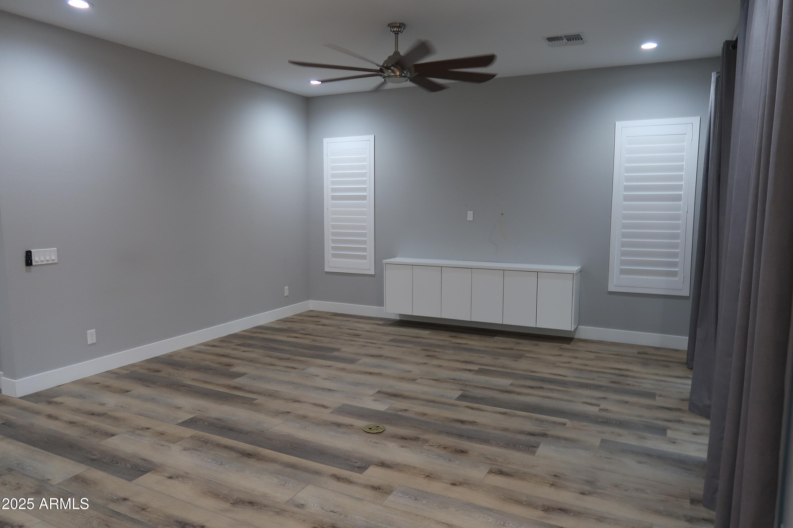 2852 East Robin Lane Phoenix, AZ 85050 - Photo 9 of 58 a view of empty room with wooden floor