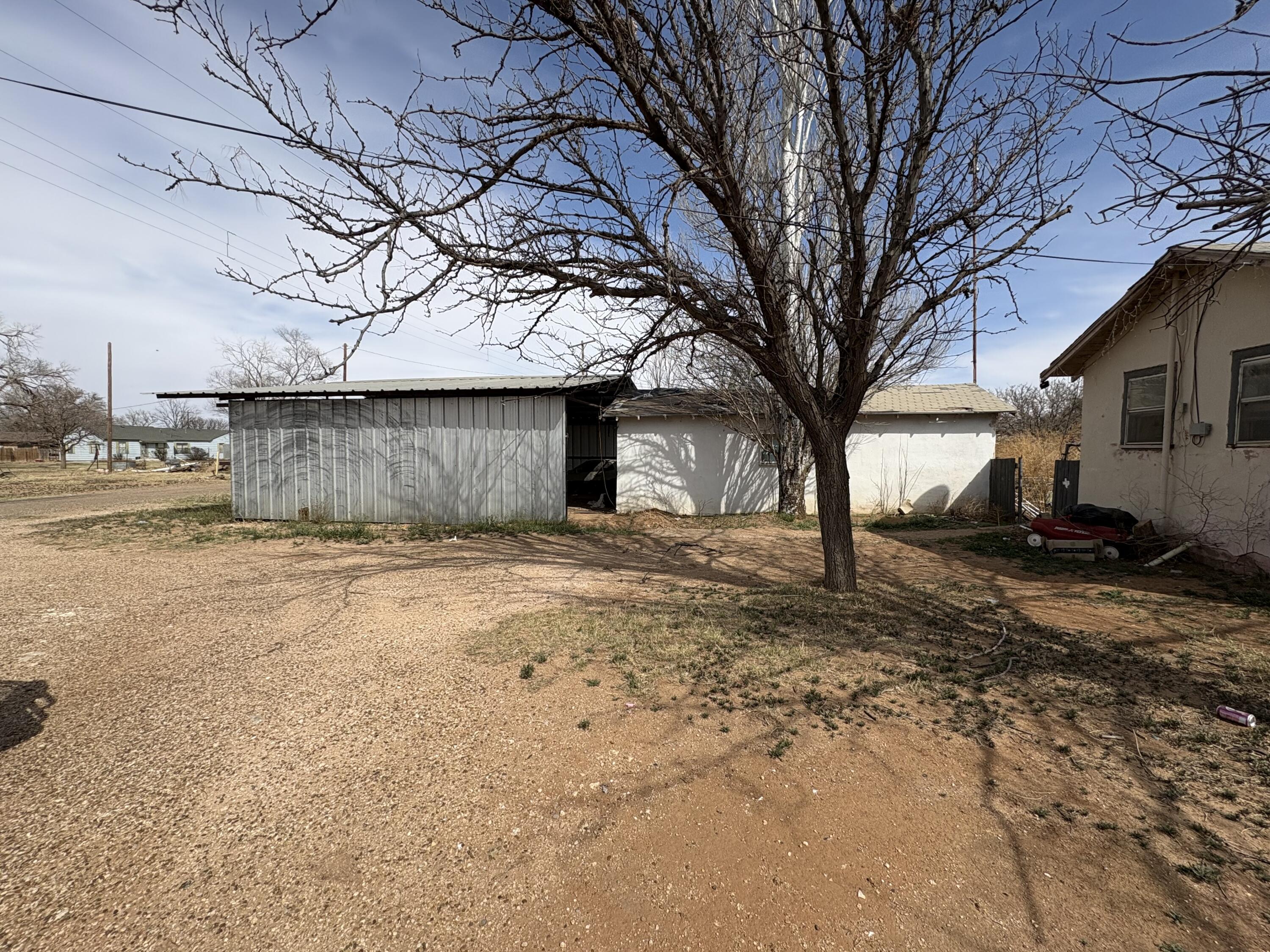 102 4th Street Whitharral, TX 79336 - Photo 2 of 4 a view of a large house with a large tree