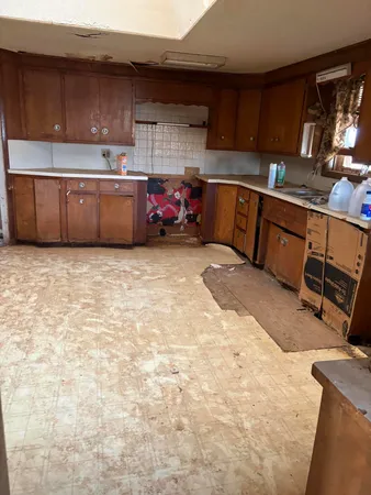 a kitchen with stainless steel appliances a stove a sink and a refrigerator