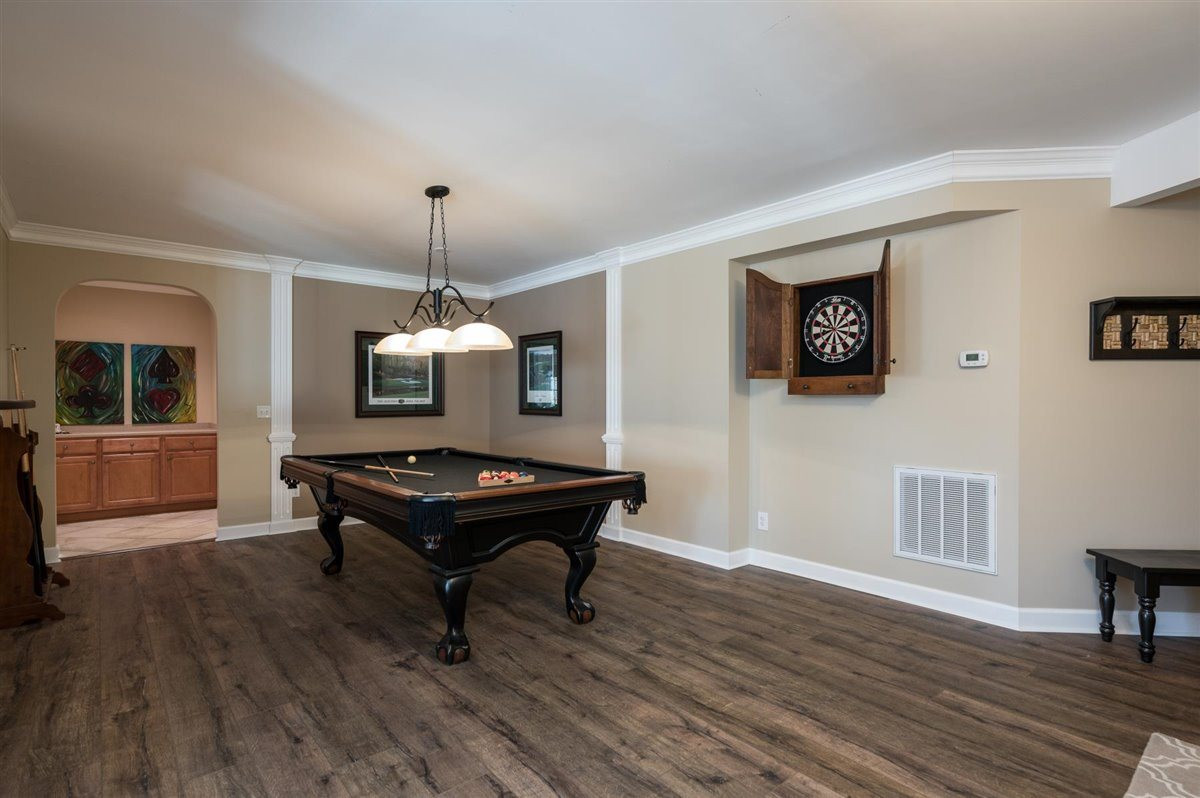 3100 Pyxis Court Raleigh, NC 27614 - Photo 16 of 30 Luxury vinyl plank flooring throughout the main areas of the basement. There's an additional snack bar and storage area that flanks this space. Finished Basement