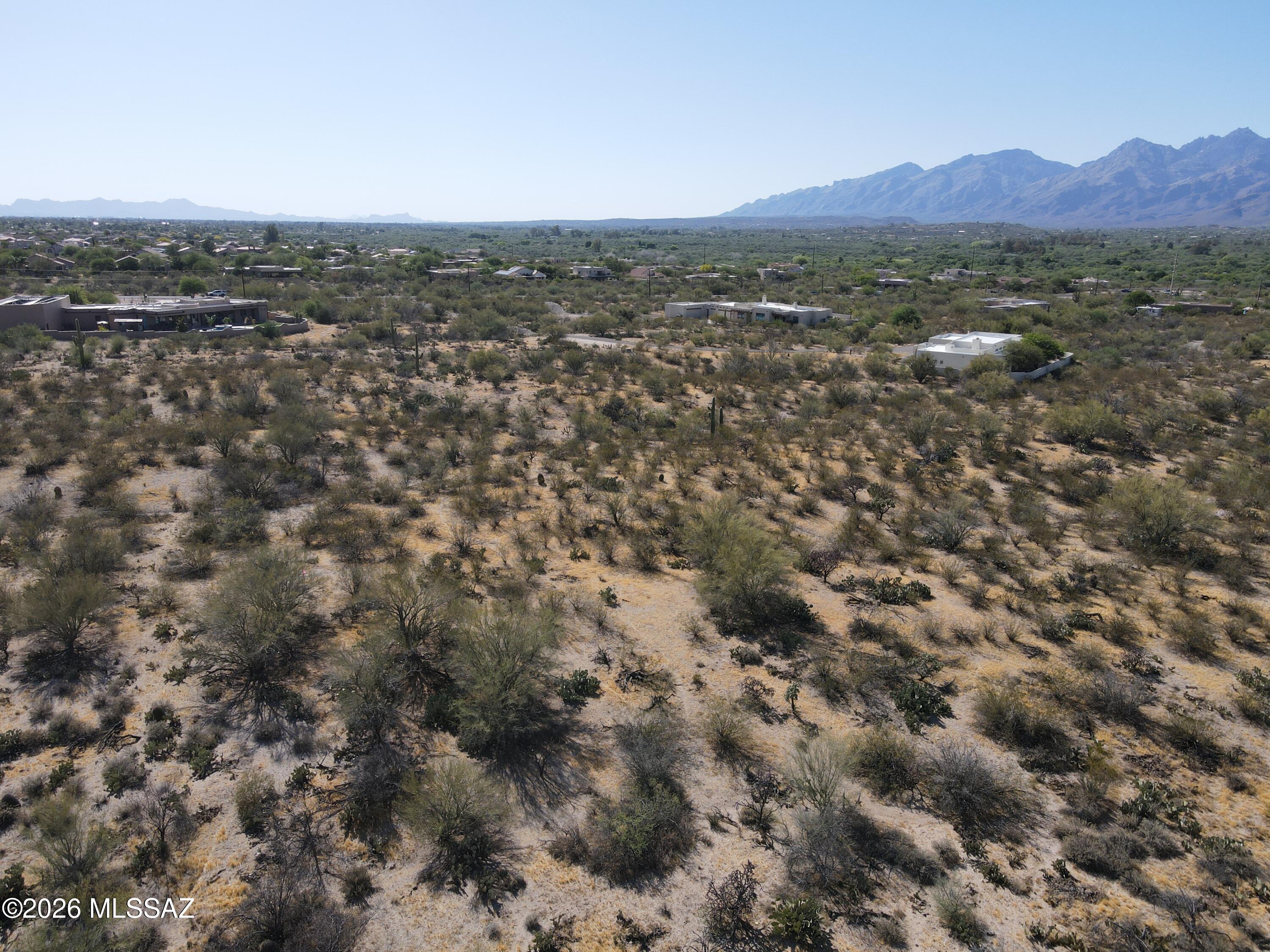 830 North Tanque Verde Loop Road, Unit 8 Tucson, AZ 85748 - Photo 7 of 10 a view of a lush green field with mountains in the background