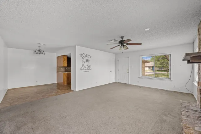 an empty room with a empty space and a ceiling fan