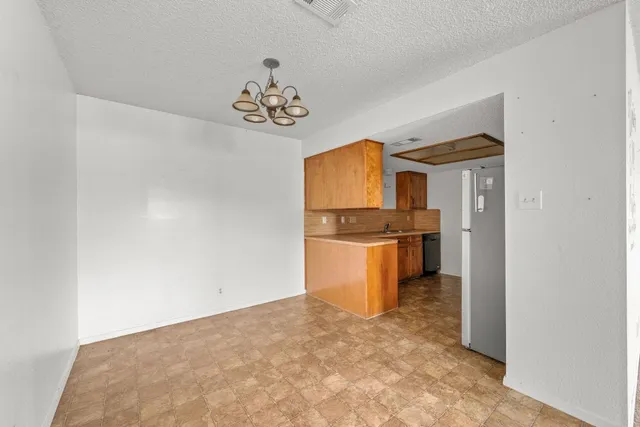 a view of kitchen and dining room with chandelier