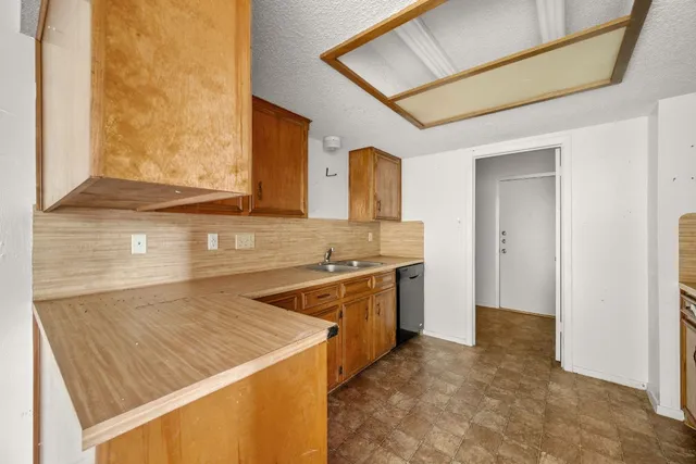 a kitchen that has a sink and a stove