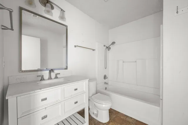 a bathroom with a double vanity sink toilet mirror and bathtub
